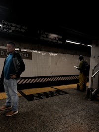 a man standing on a subway platform