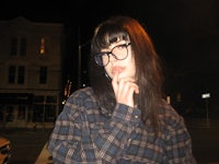 a woman wearing glasses and a plaid shirt