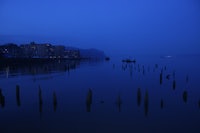 a body of water with a few wooden poles in it